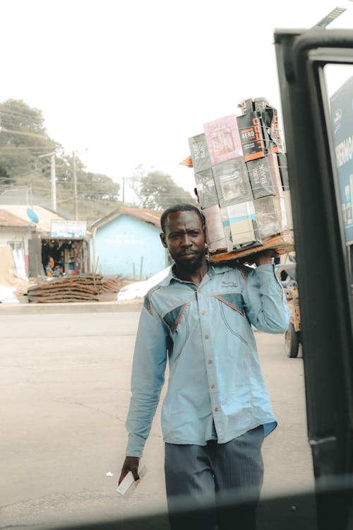 Man Carrying Packages on his Shoulder