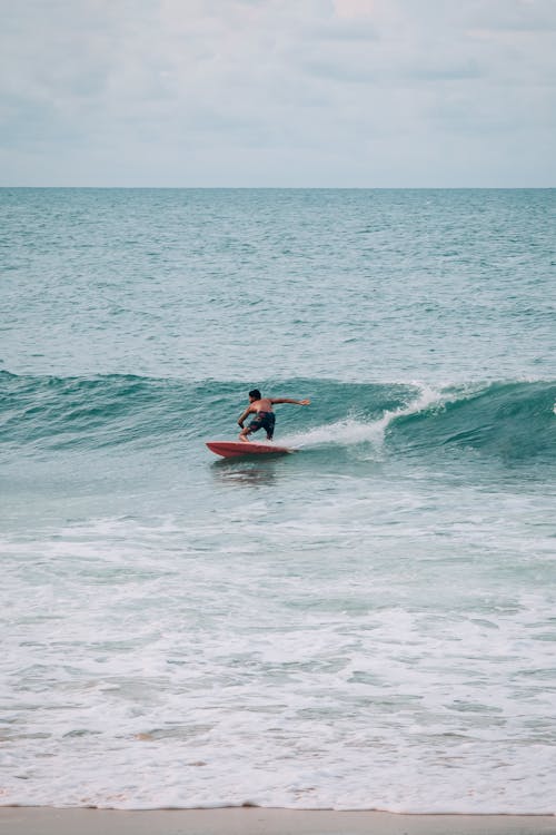 Shirtless Man Surfing Sea Wave