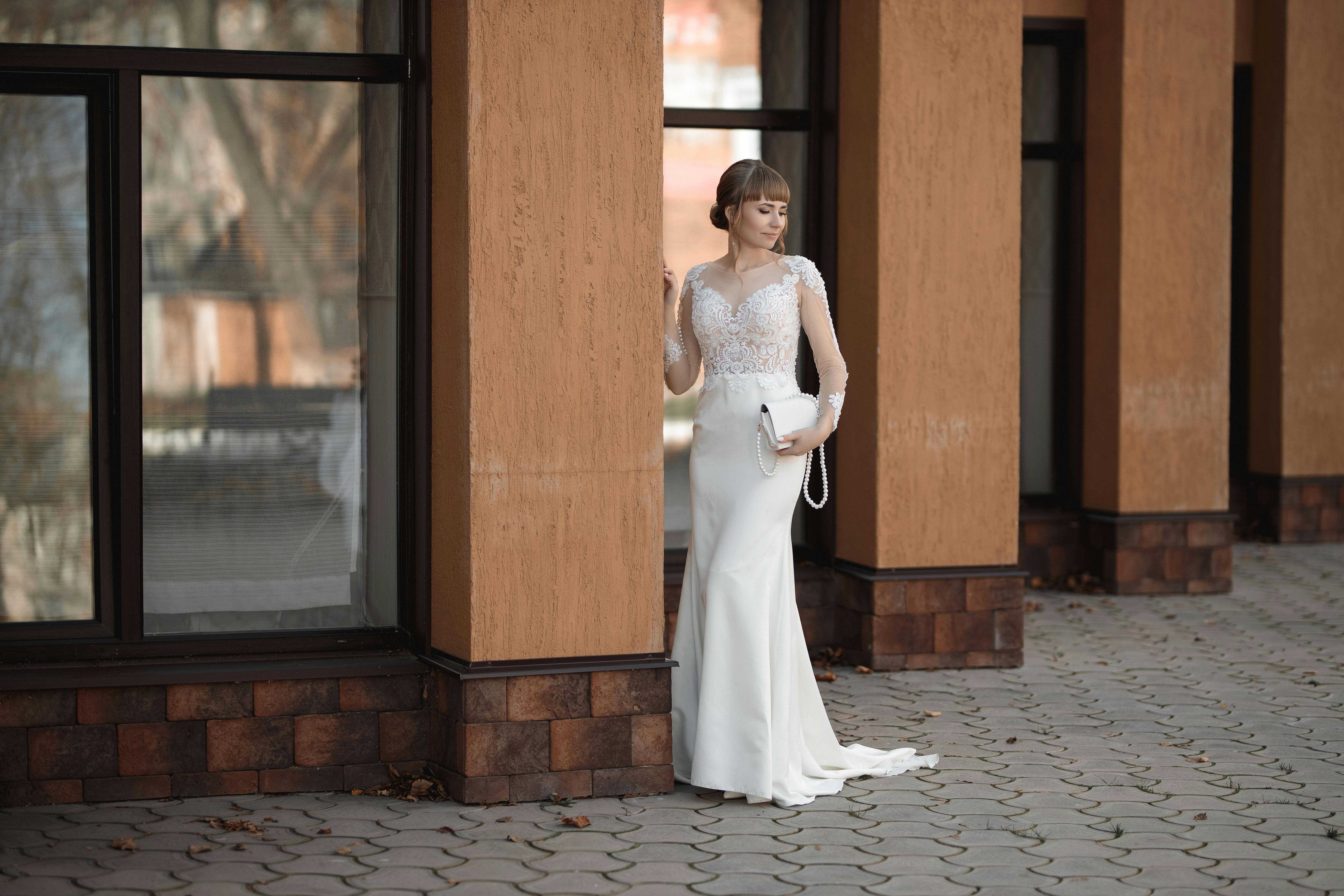 bride posing on a sidewalk