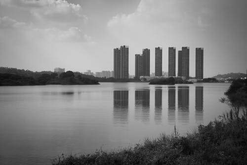 Grayscale Photo of High Rise Buildings Near Body of Water