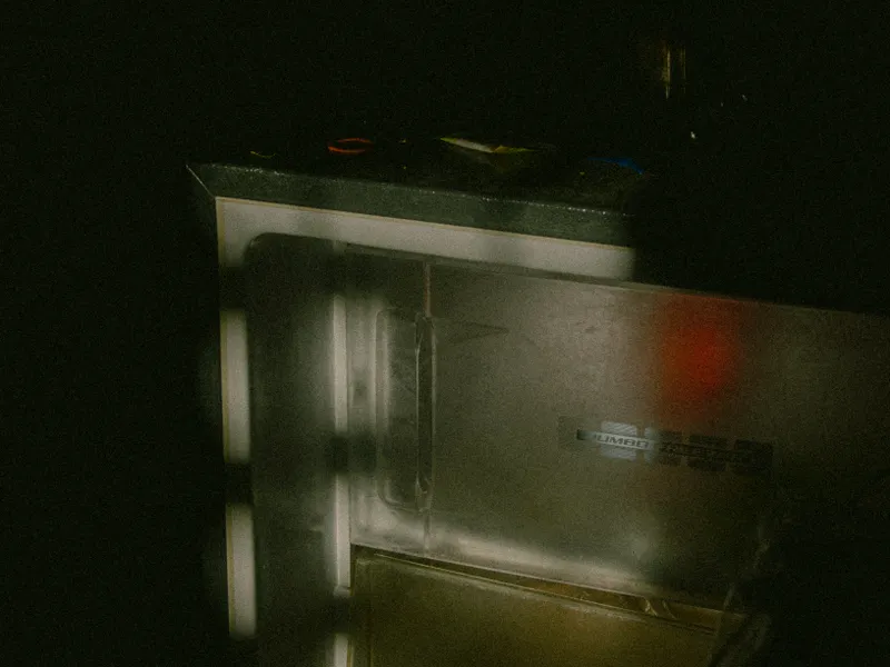 Stainless steel refrigerator standing open in a dimly lit room Stainless steel refrigerator standing open in a dimly lit room