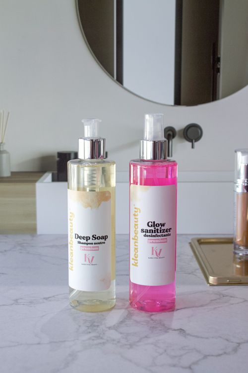 Free Elegant display of soap and sanitizer bottles on a marble counter, perfect for skincare themes. Stock Photo