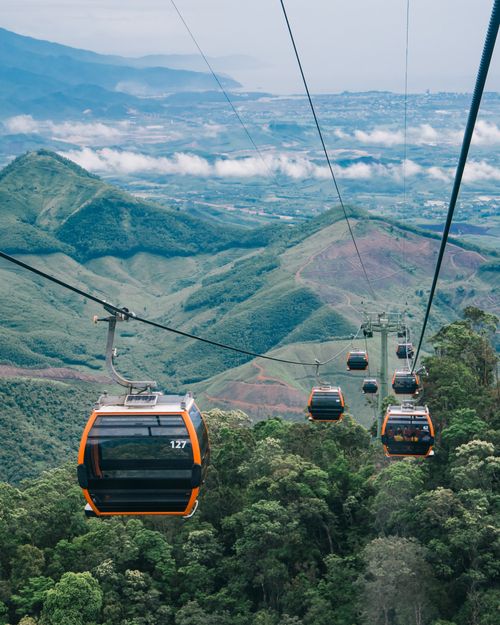 Free Experience breathtaking views from a cable car journey over lush mountain landscapes. Stock Photo