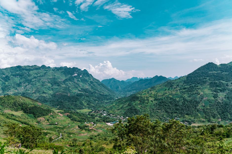 Experience the lush green landscapes and stunning mountains of Hà Giang, Vietnam captured from above.