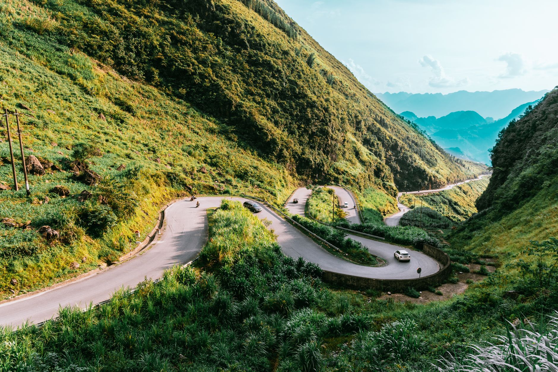 Explore the winding roads and lush green mountains of Hà Giang, Vietnam, a perfect summer landscape destination.
