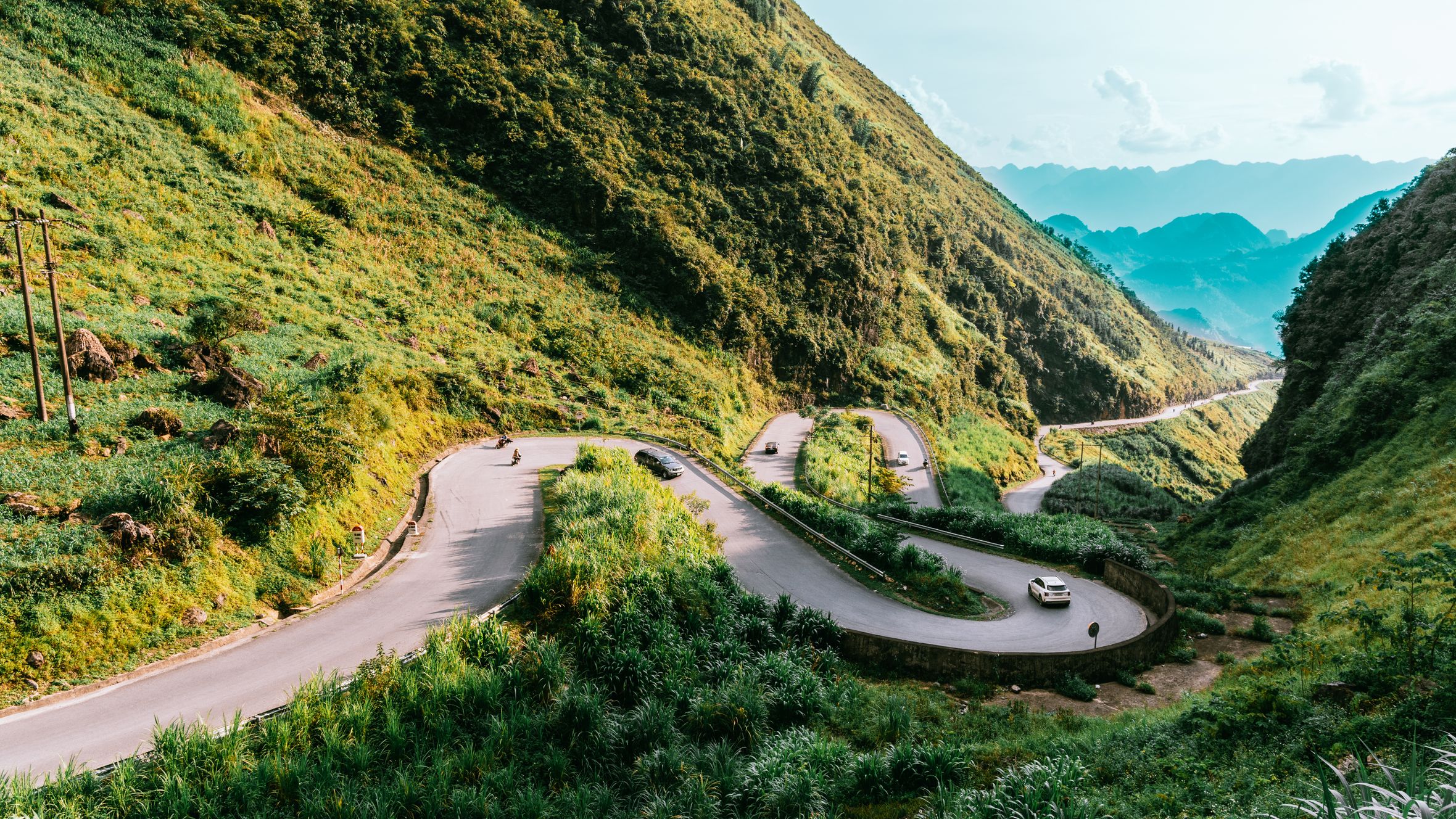 Explore the winding roads and lush green mountains of Hà Giang, Vietnam, a perfect summer landscape destination.