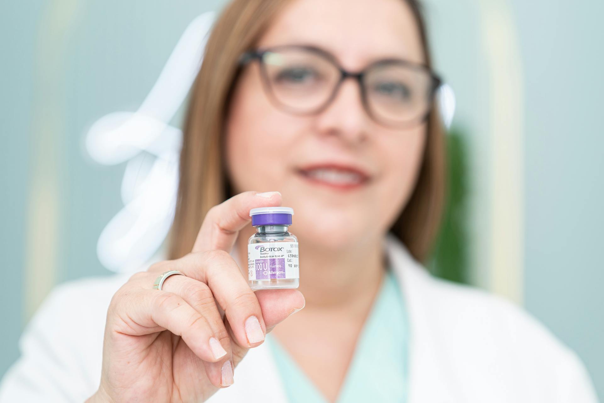 Woman Holding a Botox Bottle