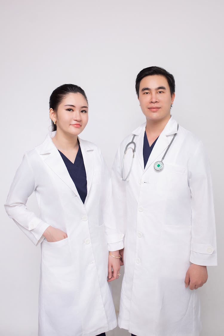 Man And Woman Doctors In Aprons 