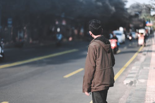 Boy Facing Right Side Of The Road