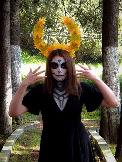 A Woman with Face Paint Wearing Black Dress