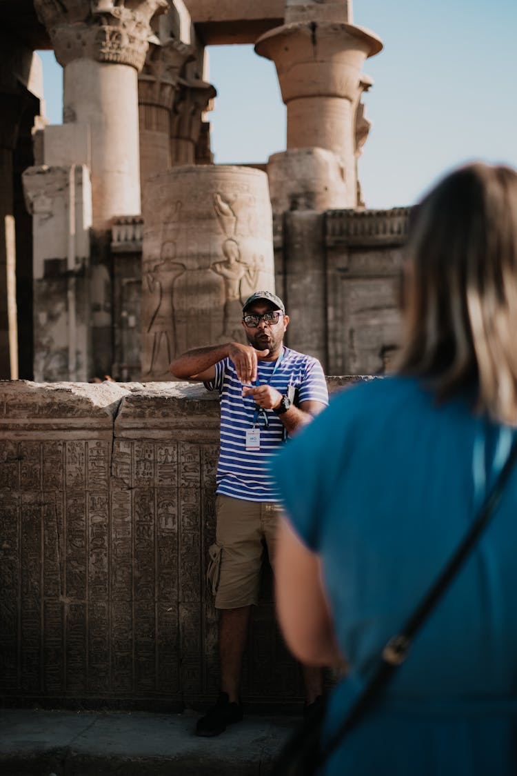 A Man In Striped Shirt Serving As Tour Guide