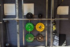A well-equipped home gym featuring a squat rack, weights, and a bench.