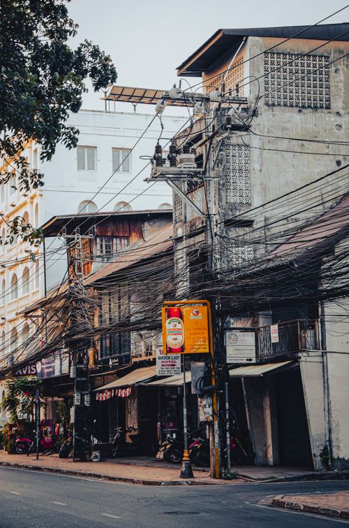 Free A bustling urban street with tangled power lines and vintage architecture. Stock Photo