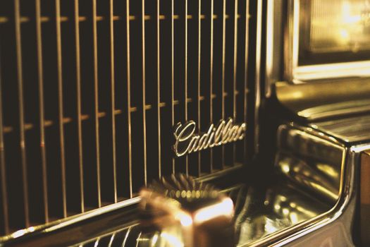 Detailed view of a vintage Cadillac car grill showcasing elegant chrome design.