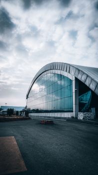 Captivating view of Badgam Airbase's contemporary architecture against a cloudy sky.
