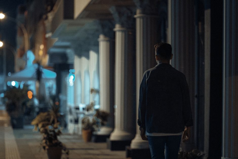 person walking alone night street
