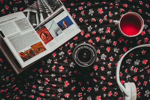 Free Black Camera Lens Beside White Headphones and Cup Stock Photo