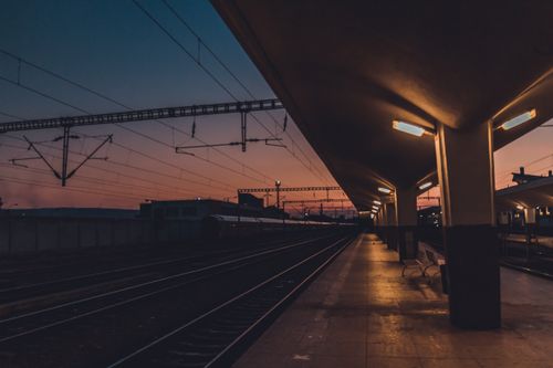 Free Captivating sunset view of Cluj-Napoca railway platform with vibrant sky and modern lighting. Stock Photo