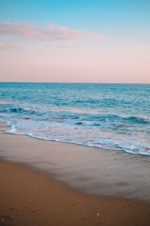 A Brown Sand Beach Under Blue Sky