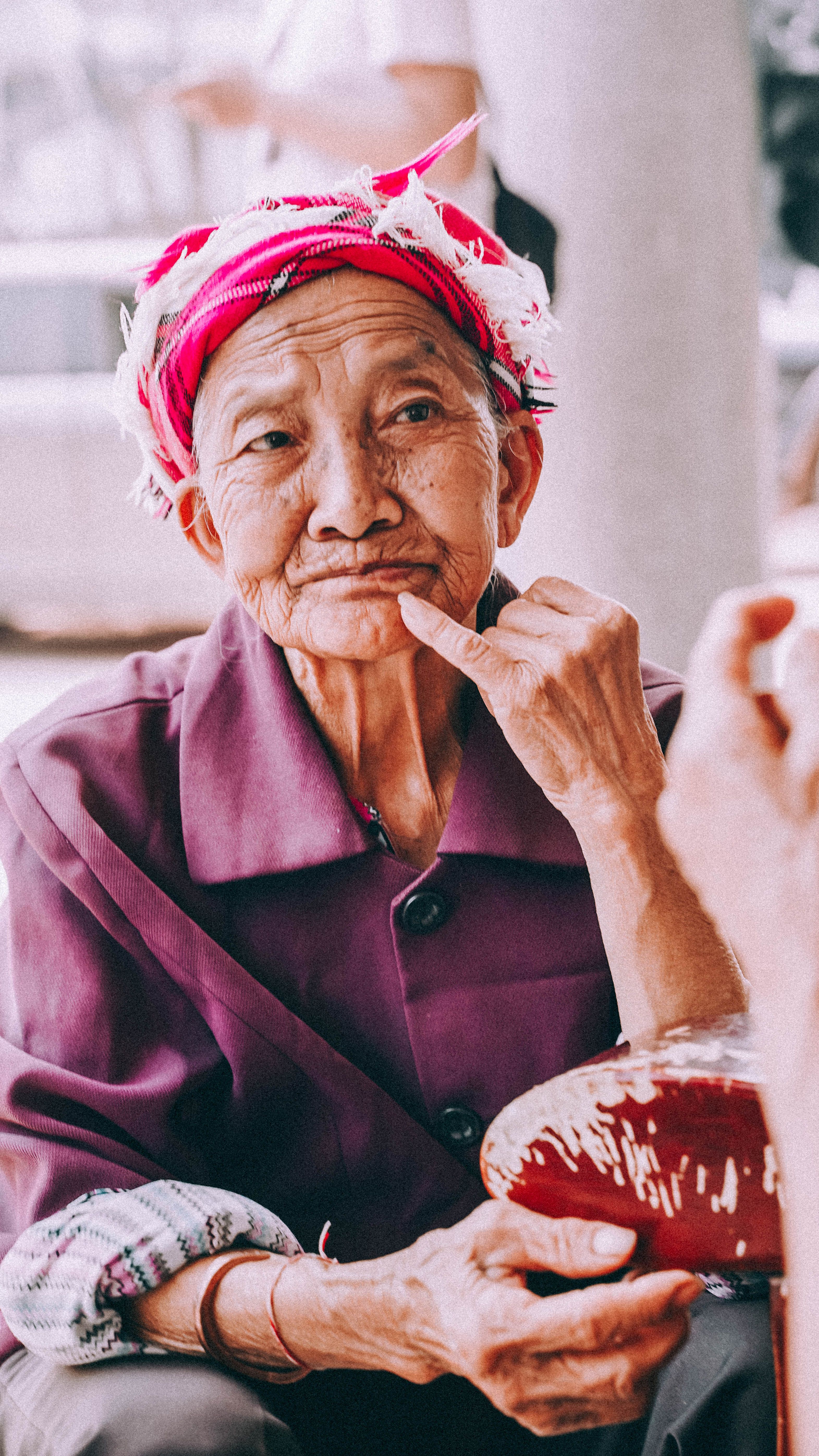 Portrait of an elderly Dai woman in traditional attire, Yunnan, China.
