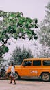 Girl Walking Near orange Vehicle