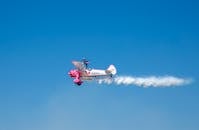 A Person Doing an Airplane Stunt on a Boeing Stearman Model 75