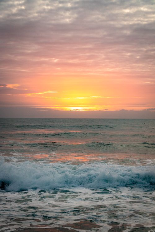 Free Peaceful sunrise at Dolphin Coast, South Africa, with vibrant colors and serene ocean waves. Stock Photo