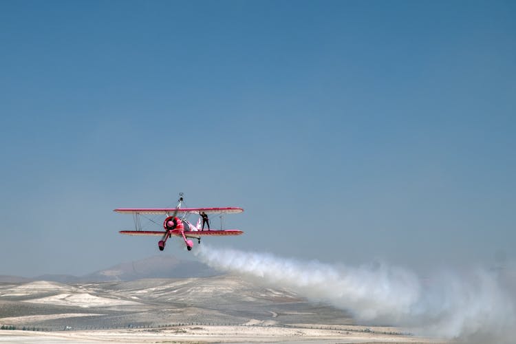 Biplane Flying Over Desert