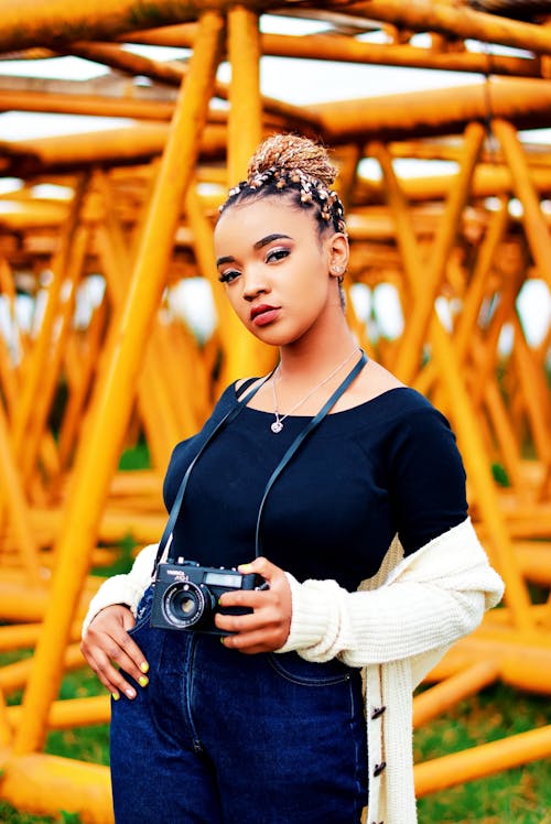 A Woman Holding an Old Camera 