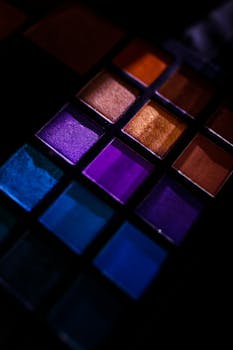 A close-up of a colorful eyeshadow palette showcasing vibrant shades for makeup enthusiasts.