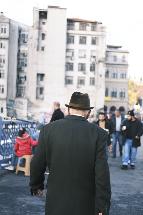 Back View of a Man in Black Suit and Hat