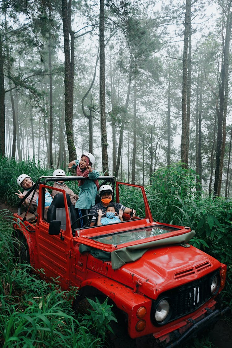 Happy Family In 4x4 Car In Forest