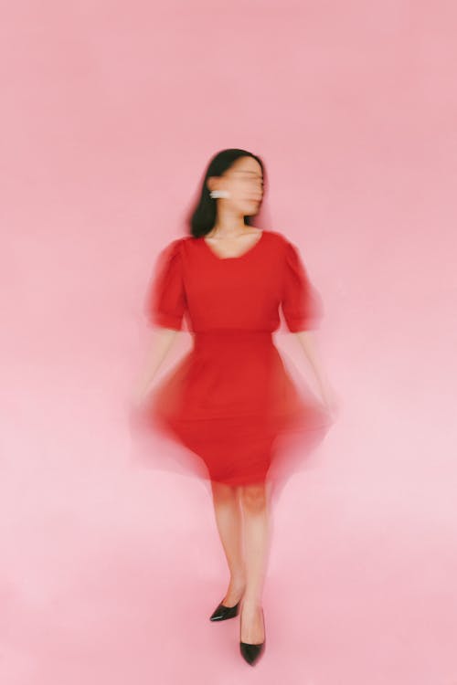 Portrait of a Woman in Red Dress a0gainst Pink Backgroud