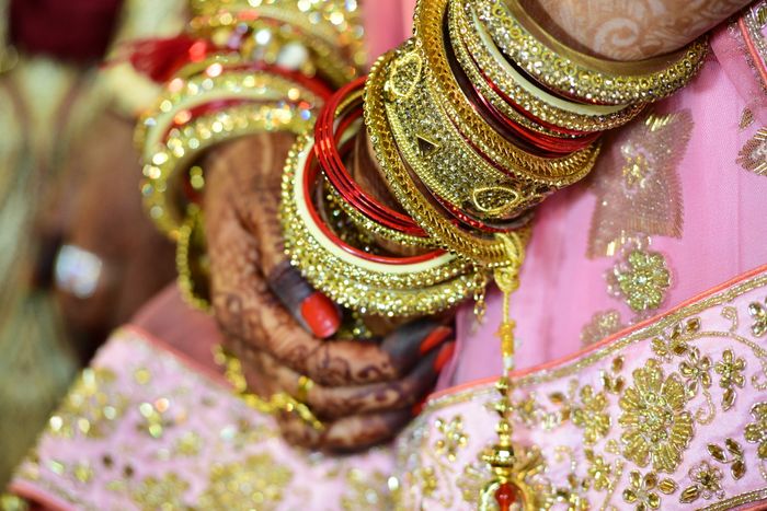 Bride's hands with mehendi and bangles