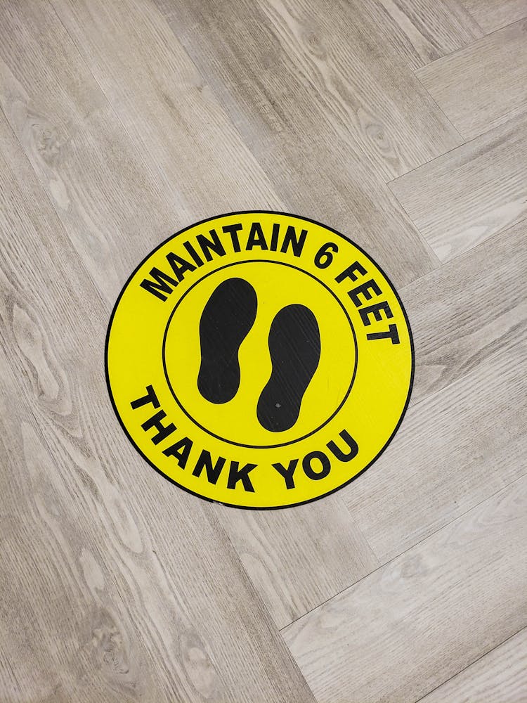 A Social Distancing Sticker On A Floor