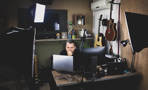 Free Man Siting in Front of Computer Monitor Stock Photo