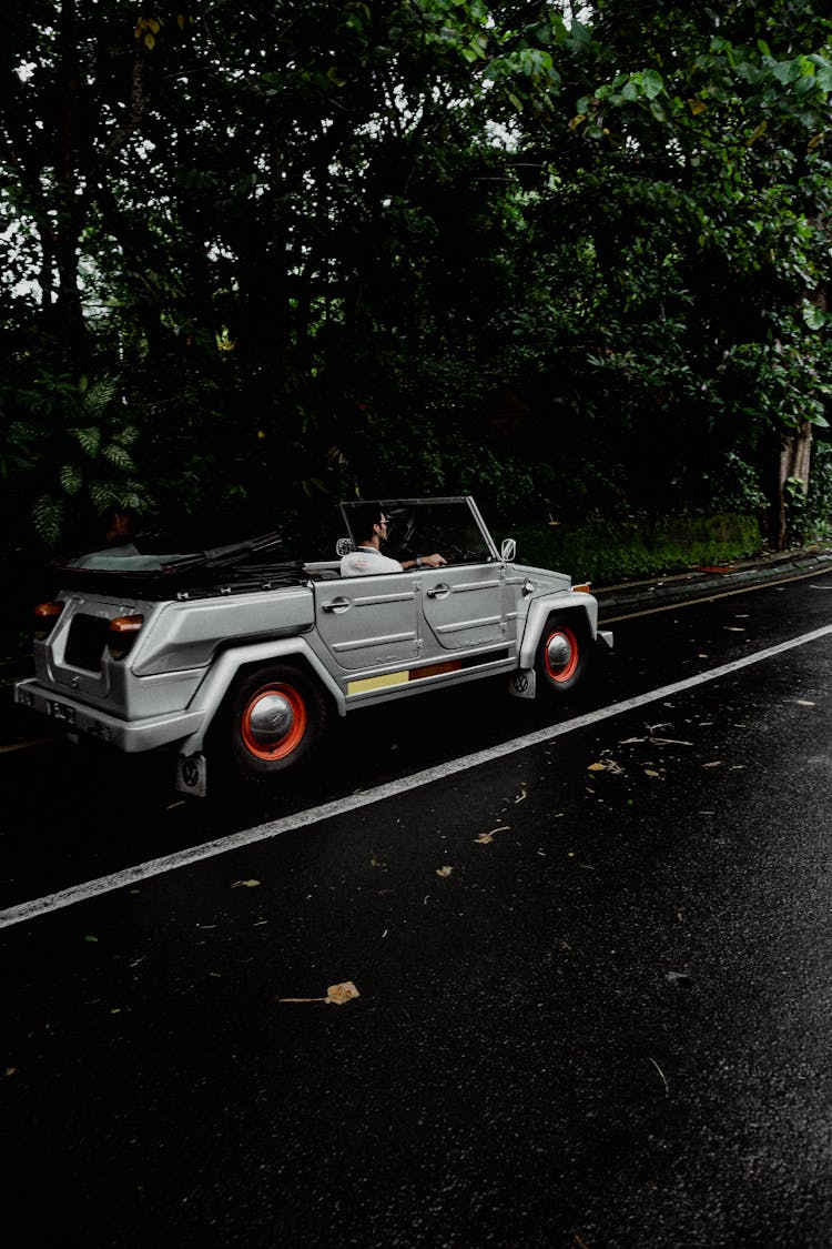 A Person Driving A Convertible Car 