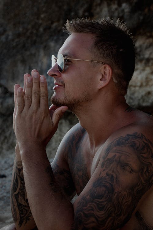 Man in White Framed Eyeglasses and Black Tattoo on His Right Hand