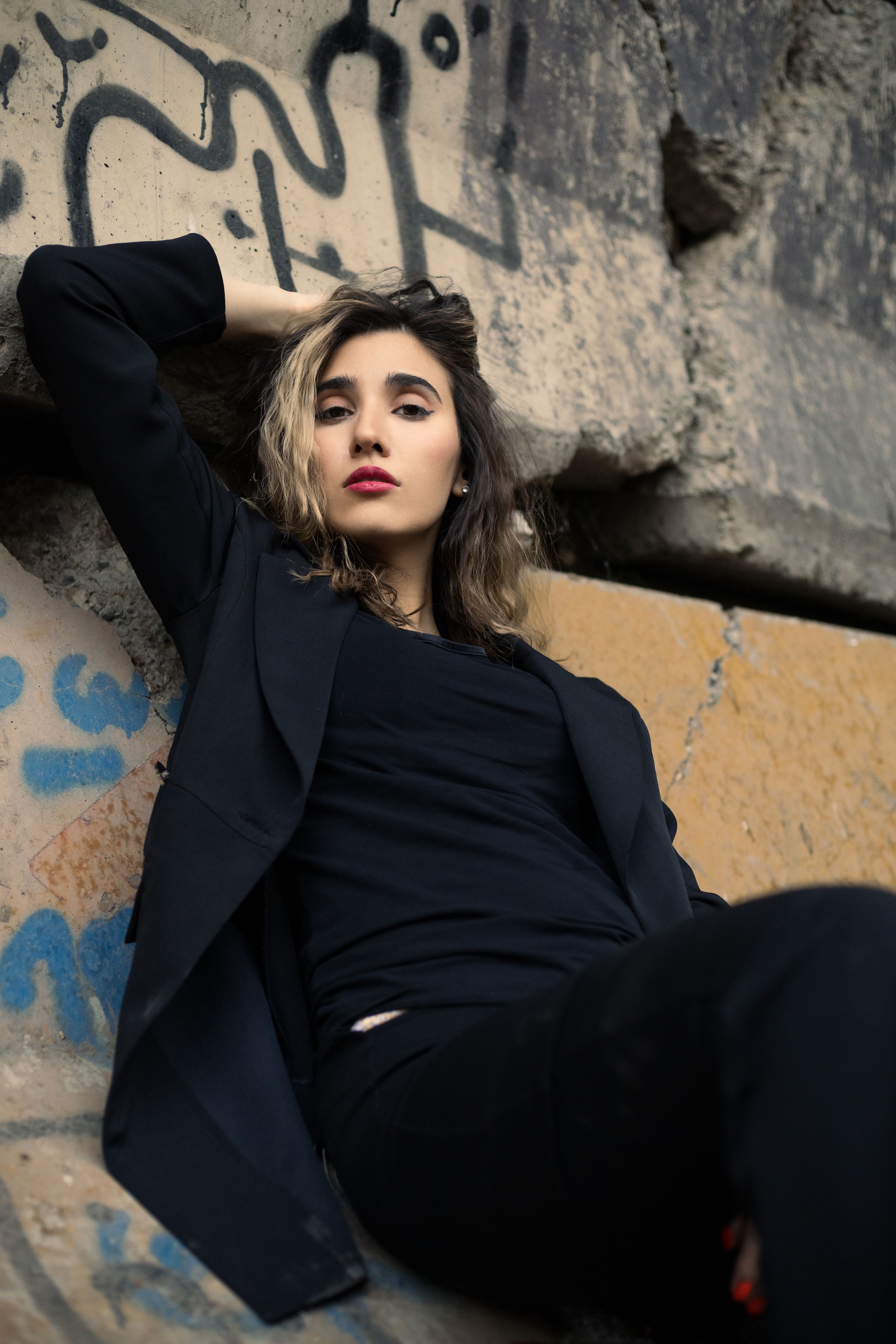 Woman in Black Clothes Standing Beside Concrete Stairs · Free Stock Photo