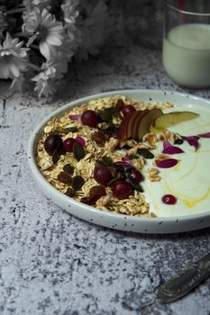 A rustic breakfast bowl with granola, yogurt, fruits, and seeds, perfect for a healthy start.