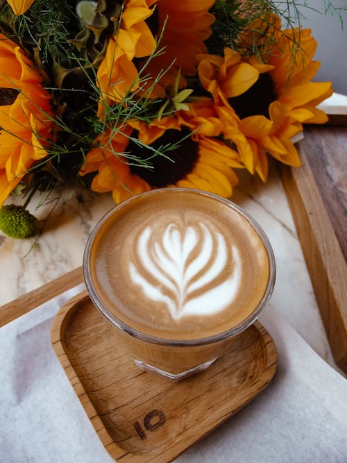 Cup of Latte Art on Wooden Coaster