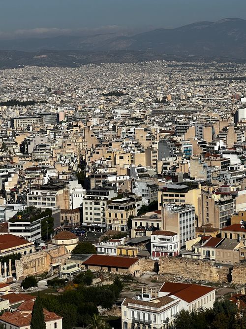 Free Aerial view of Athens, Greece showcasing a dense urban landscape with mountains in the background. Stock Photo