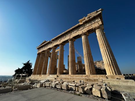 Explore the ancient grandeur of the Parthenon under a clear blue sky in Athens, Greece.