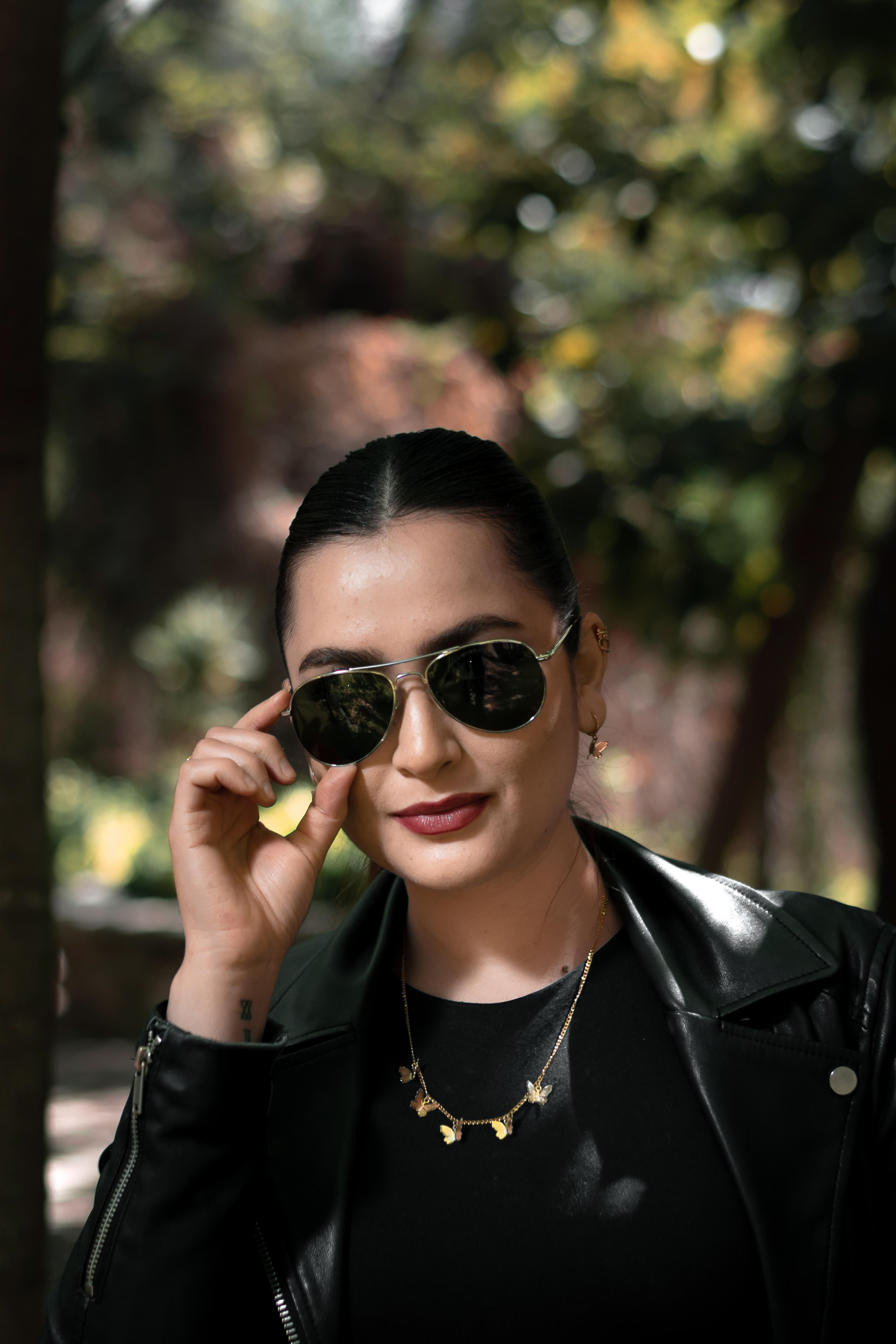 A Woman in Black Leather Jacket Wearing Sunglasses · Free Stock Photo