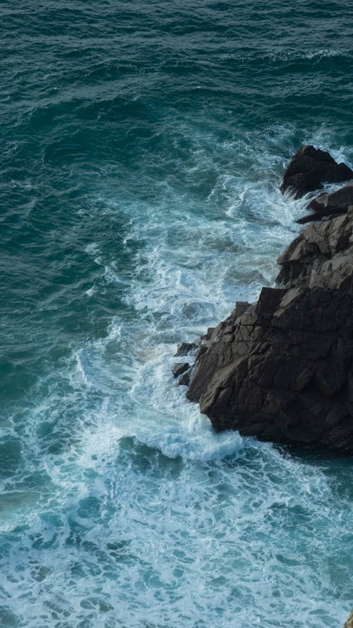 Sea Waves Breaking against a Rock 