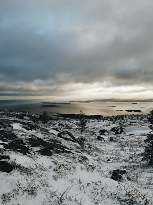 View of the Sea seen from a Snowy Hill 