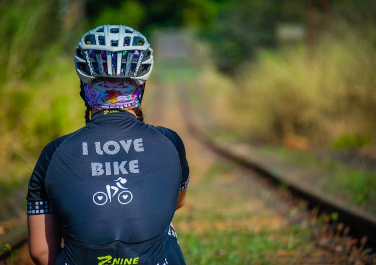 Back View Of A Person In Bike Jersey And Helmet 