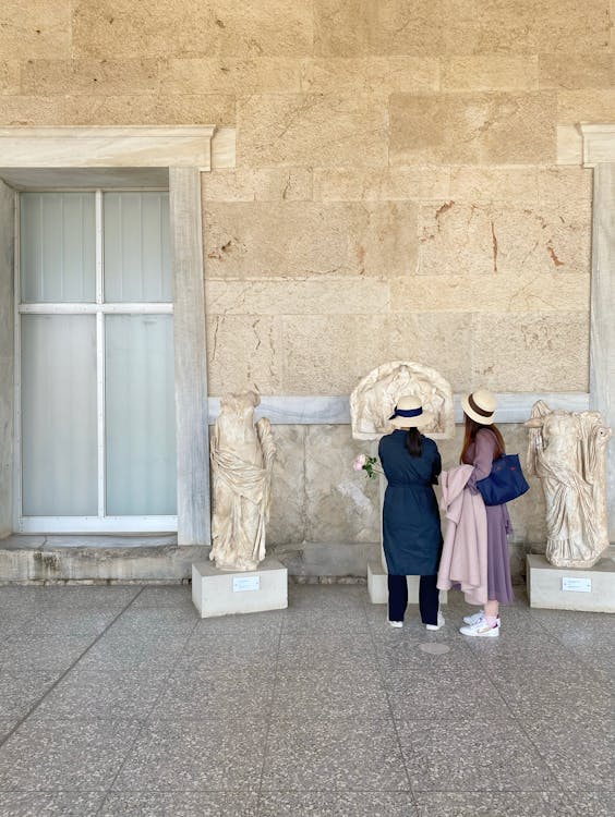 Girl in Black Jacket Standing Beside White Wooden Door