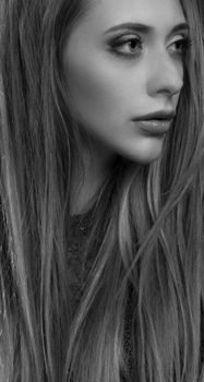 Black and white portrait of a woman with long hair, showcasing elegance and beauty.