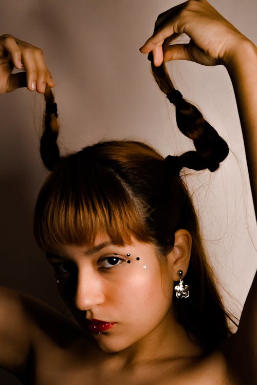 A Woman Holding her Ponytails